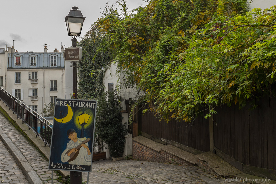 A restaurant sign on Rue Poulbot, Montmartre, Paris