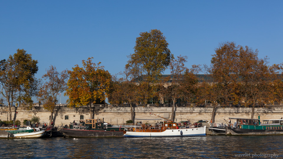 Tourist boats on the Seine River against Musée de l\'Orangerie on the Right Bank, Paris