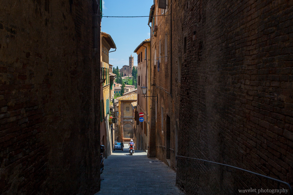Overlook the church of Santa Maria dei Servi through the narrow street, Siena