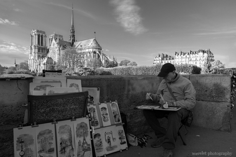 A painter near Pont de l\'Archevêché, Paris