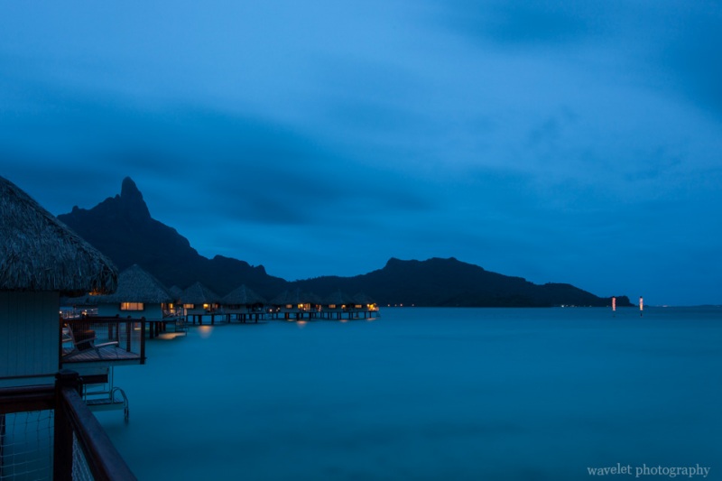 Night view of overwater bungalows of Le Méridien Bora Bora again Mount Otemanu